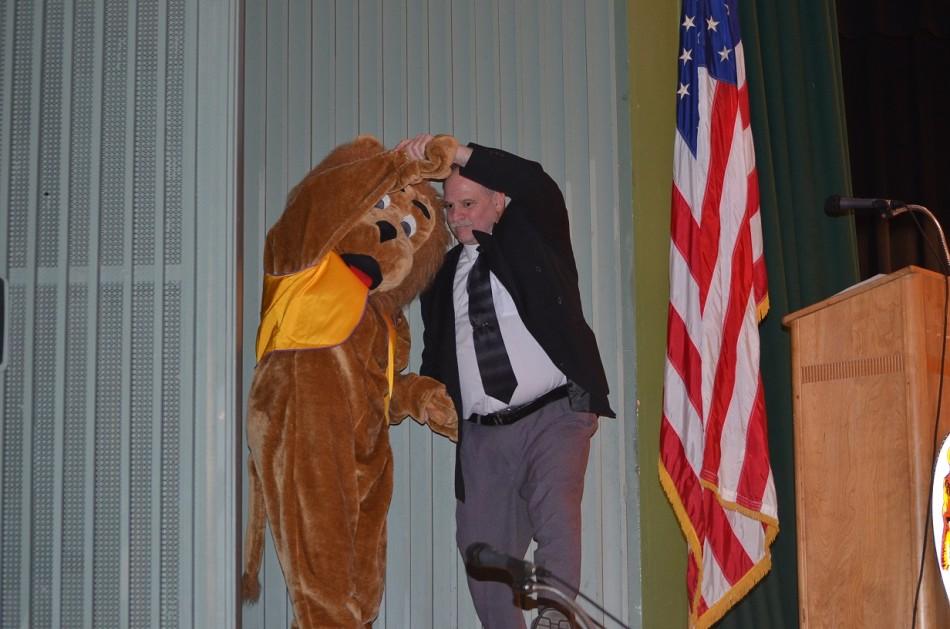 Mr. DiSanza dance with the Lions Club mascot during a song played by the middle school jazz band 