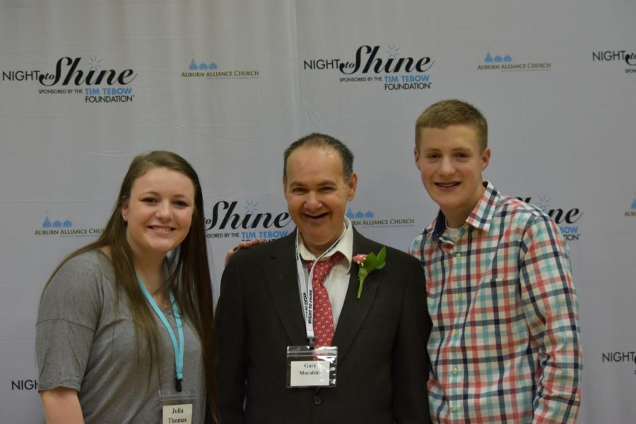 Weedsport alumna Julia Thomas and current student Landon Kepple pose for a photo with one of the evening's participants.