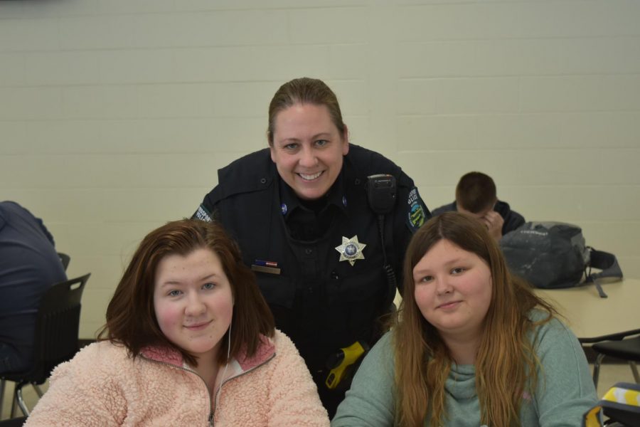 Officer+Quigley+takes+a+moment+out+of+her+day+to+share+a+smile+with+Weedsport+freshmen+Maddie+Higgins+and+Brooklyn+Smith.