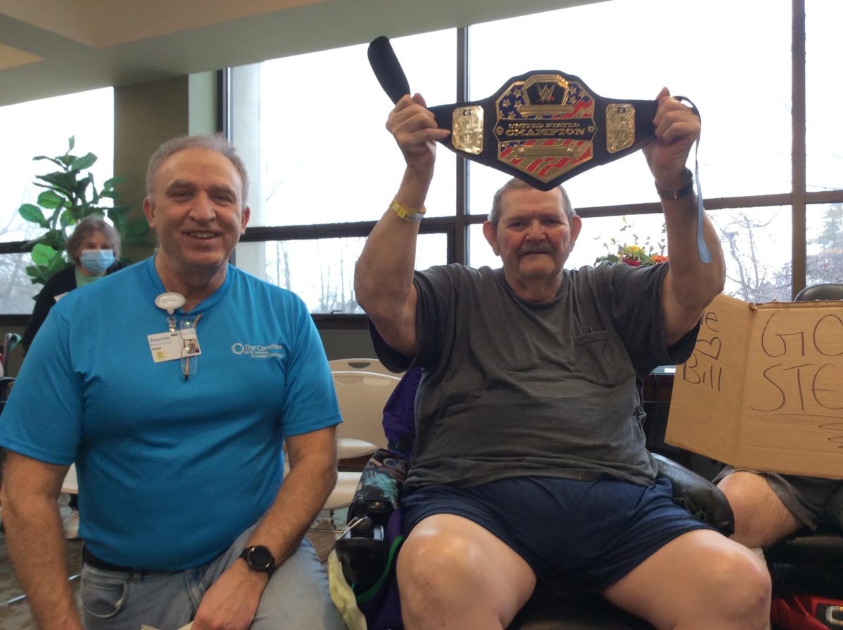 Bill+Sliter+holds+up+the+championship+belt+he+won+in+his+arm-wrestling+fundraiser+with+Steve+Perrone.